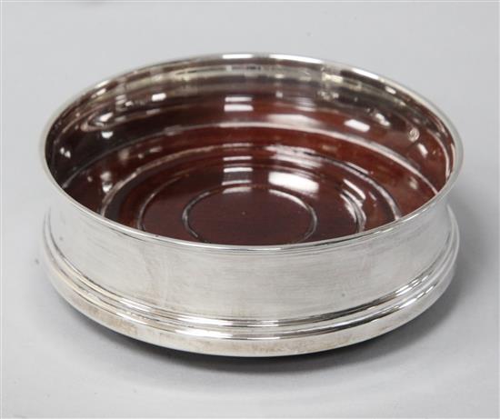 A modern silver mounted bottle coaster, 10cm.